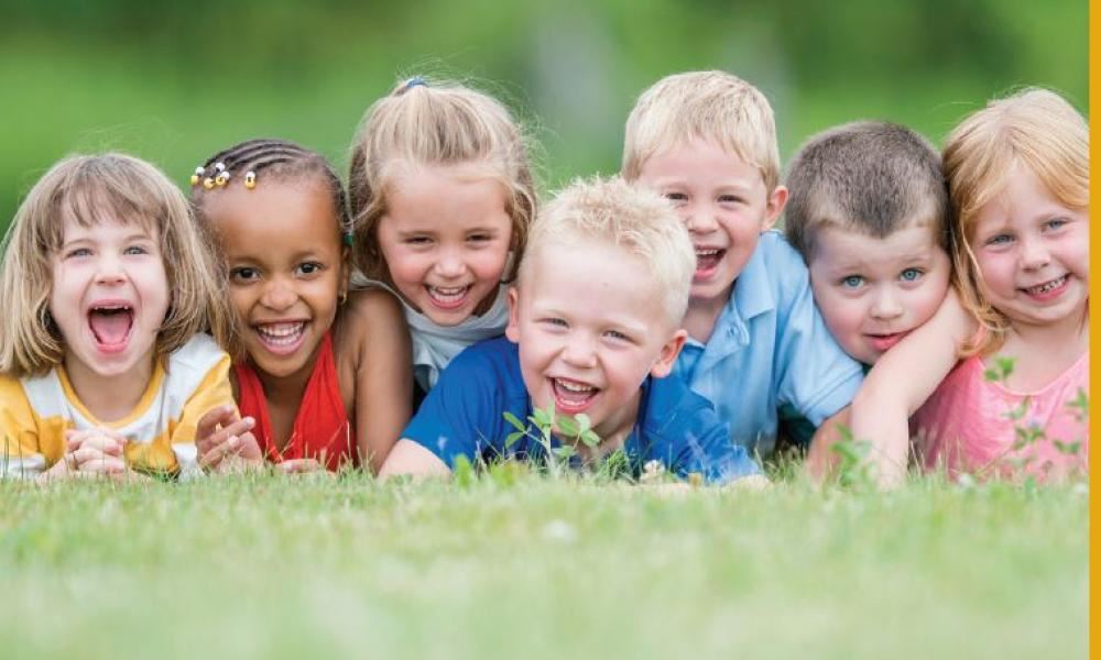 Children laying on the grass making new friends 